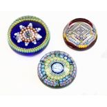 Three glass paperweights to include example with internal start decoration, signed and dated 1983,