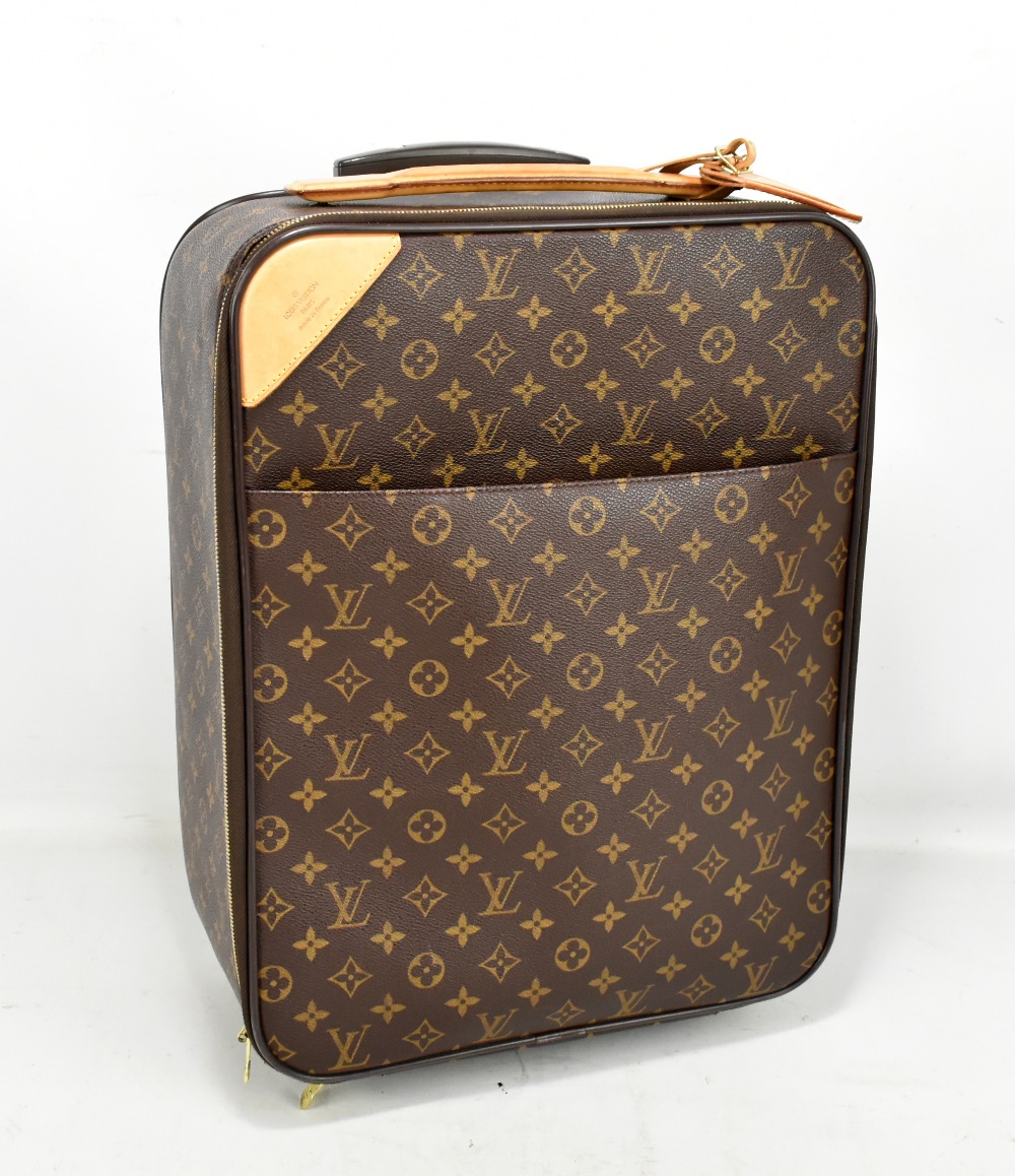 LOUIS VUITTON; a Pegase Cloth cabin sized suitcase, with brown monogram coated cloth, and nude