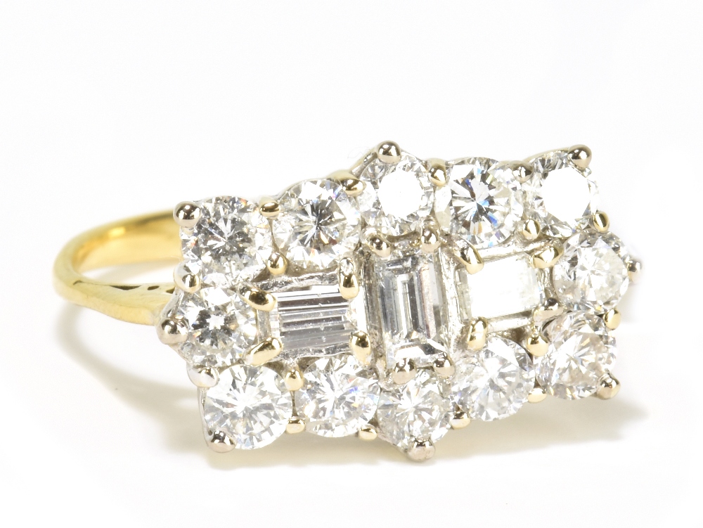 A yellow metal diamond ring with three central rectangular diamonds within a border of twelve