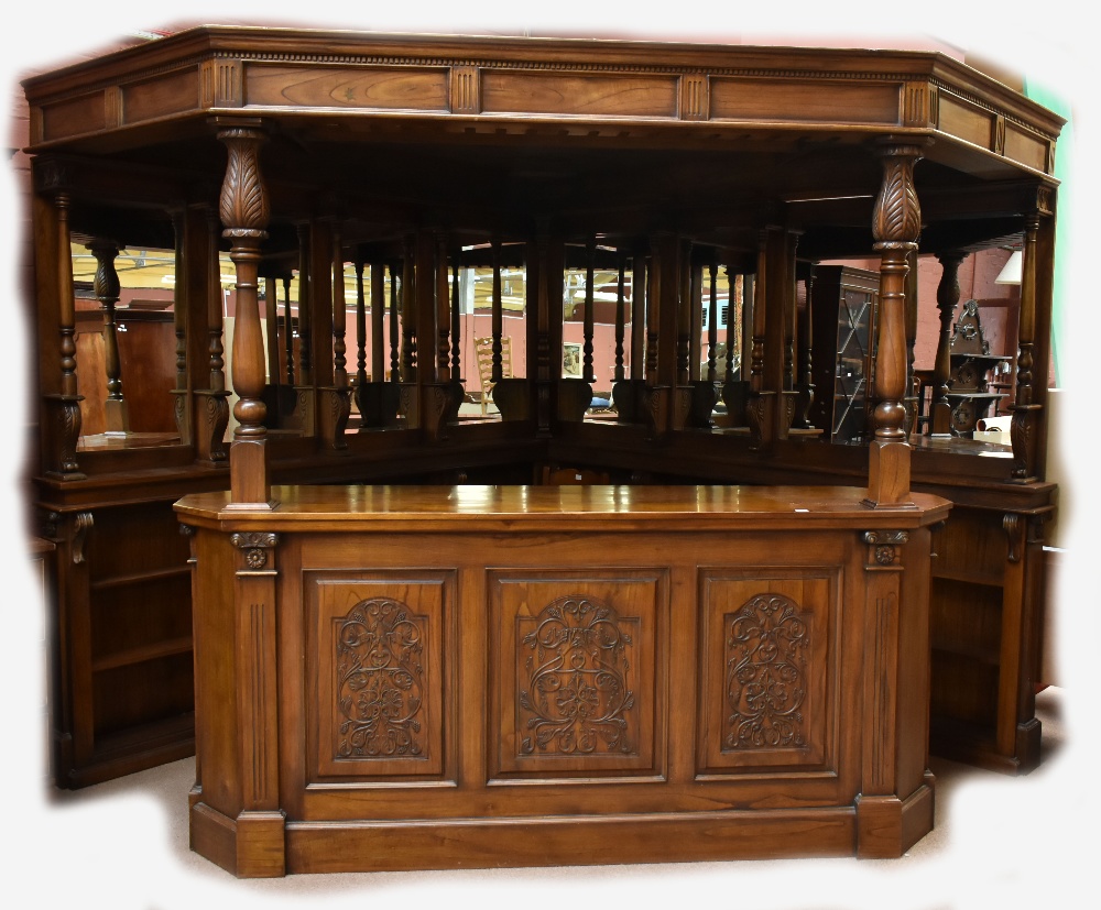 A large and impressive bar with triangular sectioned canopy above eight bevelled mirrors flanked