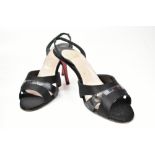 CHRISTIAN LOUBOUTIN; a pair of black leather open toe sling back sandals, size 38c. Bought by the