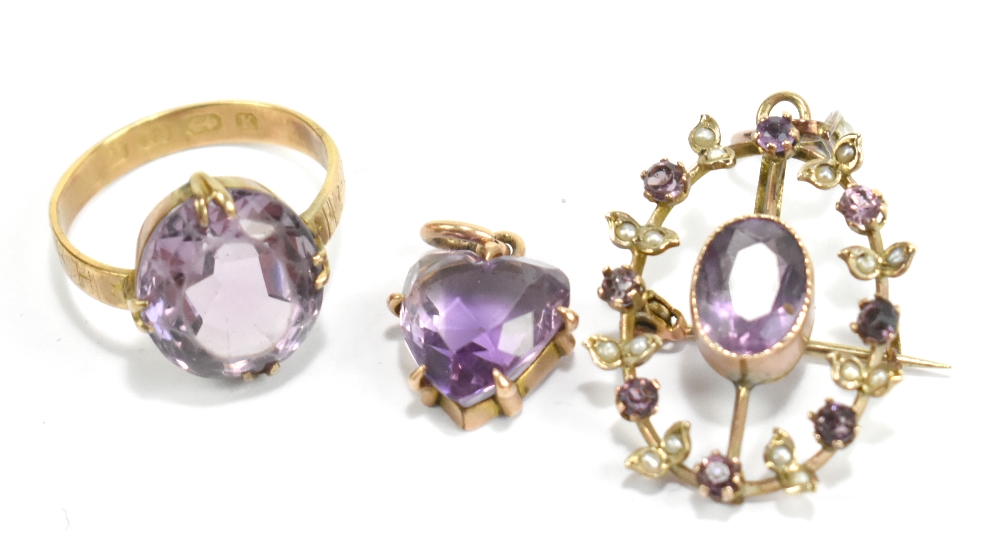 An 18ct yellow gold ring set with pale purple central stone, a similarly decorated pendant/brooch