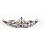 A late 19th/early 20th century yellow and white metal openwork brooch set with sapphires and