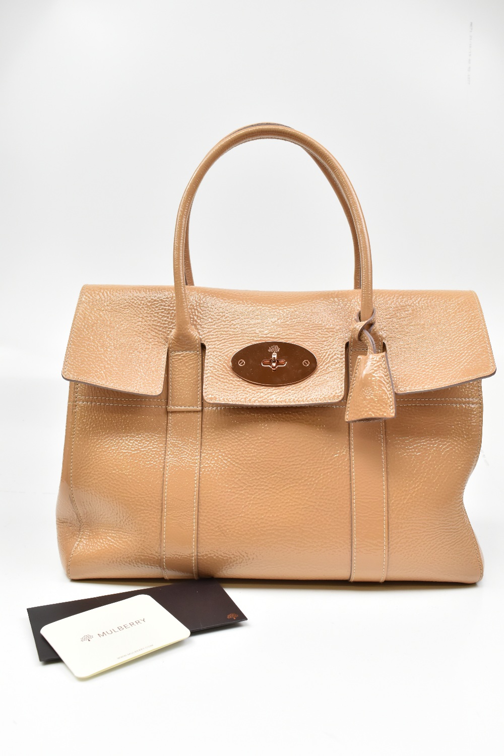 MULBERRY; a bayswater 'nude' patent leather handbag sold with correct dust bag, care card and