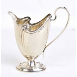 SPURRIER & CO; an Edward VII hallmarked silver Art Nouveau cream jug, with repoussé detail to oval