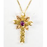 An 18ct yellow gold floral motif cross pendant set with oval cut purple coloured stone and