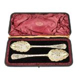 WILLIAM RAWLINGS SOBY; a pair of William IV hallmarked silver berry spoons with repoussé foliate