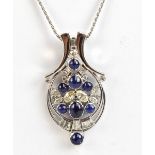 A good white metal diamond and sapphire openwork pendant set with cabochon sapphires and marquis,