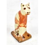 An early 19th century Bovey Tracey cream glazed model of a seated cat, height 8.7cm.Additional