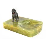 An Art Deco green onyx pin dish surmounted with a cold painted poodle, length 14.5cm.