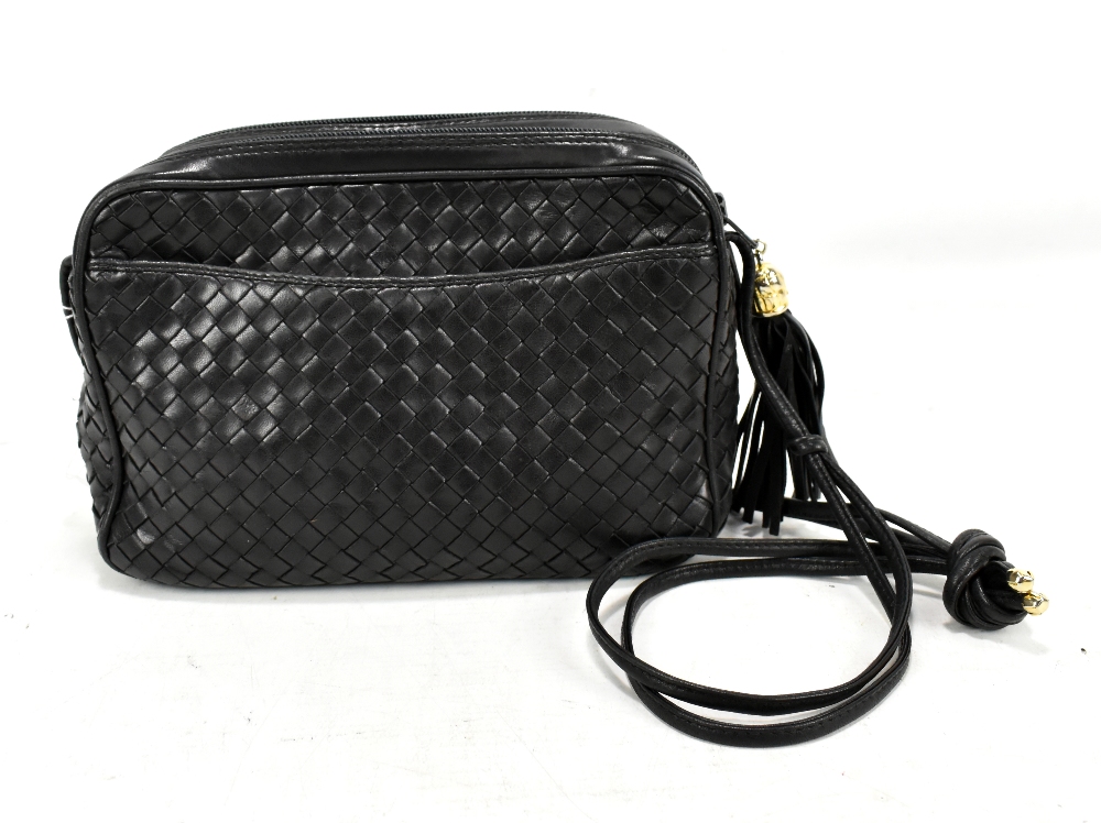 COSCI, ITALY; a navy blue woven leather shoulder bag with gold hardware, tassel and leather shoulder