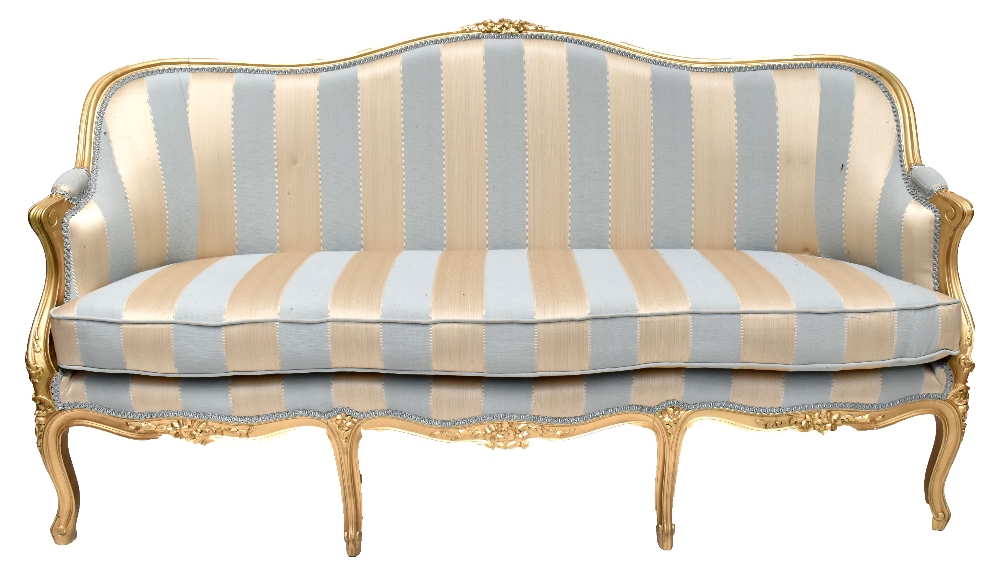 A 19th century gilt wood settee in the French taste with floral carved detail, striped padded back