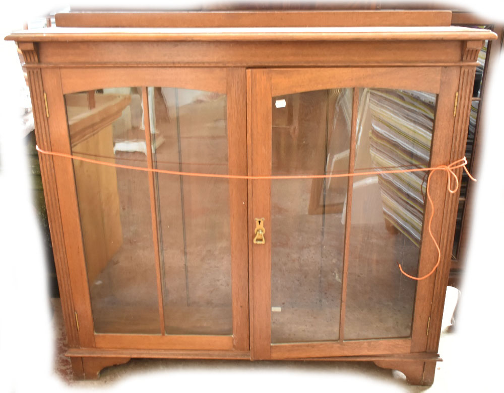 An oak bookcase with glazed doors.