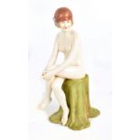 ROYAL DUX; an Art Deco figurine of a nude seated lady wearing a hat, with embossed triangle mark