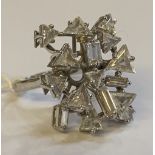 An 18ct white gold and diamond set abstract ring of elaborate construction set with baguette and