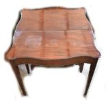 A Victorian mahogany serpentine foldover tea table, width 86cm.