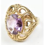 A large 9ct yellow gold dress ring set with purple coloured stone, size N, approx 6.2g.