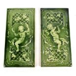 MINTONS; a pair of large green glazed tiles each decorated with a putto playing the cymbals and