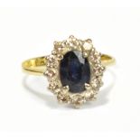 An 18ct yellow gold, diamond and sapphire cluster ring, mark to band interior, size L 1/2, approx