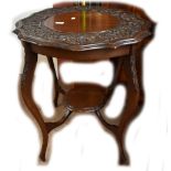 A carved mahogany occasional table, height 73cm.