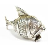 A novelty late 19th/early 20th century white metal pepperette in the form of a fish with hinged