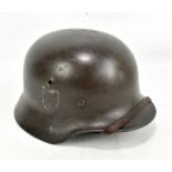 A WWII Third Reich SS helmet with partial single SS rune decal and interior leather liner,