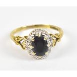 A 9ct yellow gold sapphire and diamond oval dress ring, size R , approx 2.9g.