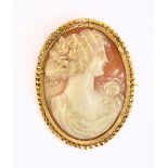 A yellow metal cameo brooch, with a carved maiden in classical dress, approx 16.2g.