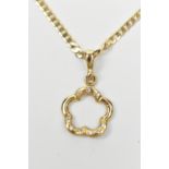 A 9ct yellow gold flat link chain supporting a petal shaped open work pendant set with nine tiny