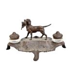 A circa 1900 spelter ink standish centred with a dog with pheasant in its mouth, flanked by glass