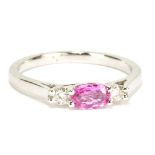 An 18ct white gold pink sapphire and diamond three stone ring, size O, approx 3.3g.