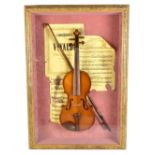 A decorative display containing a quarter or half size violin, in 3D case, framed and glazed.