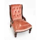 A Victorian mahogany framed button back nursing chair in pink upholstery, on turned front legs to
