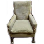 A 19th century armchair in green upholstery on turned front supports to castors.Additional