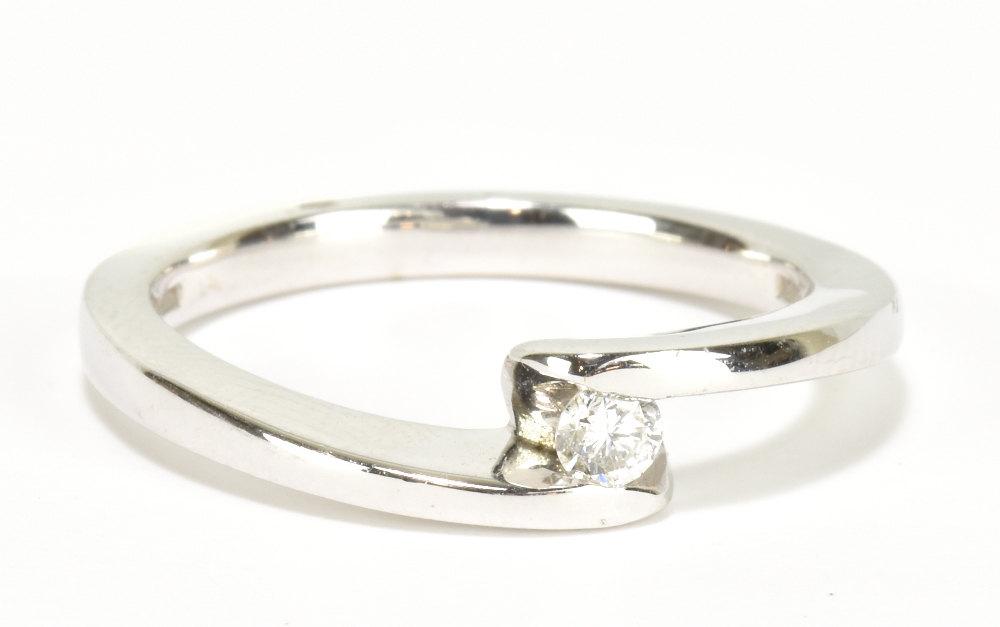 A 9ct white gold diamond solitaire ring with crossover shank, size O, approx 3.8g.