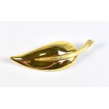 GIVENCHY; a vintage gold toned metal leaf brooch with embossed logo, length 7cm.