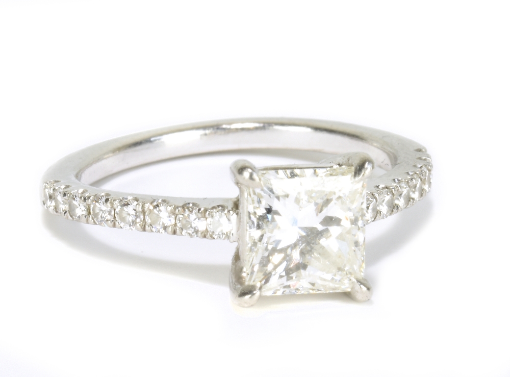 A platinum and diamond solitaire ring with central princess cut diamond weighing 1.52cts, with
