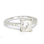 A platinum and diamond solitaire ring with central princess cut diamond weighing 1.52cts, with