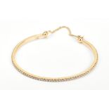 MESSIKA OF PARIS; an 18ct yellow gold and diamond set child's/baby's bangle, approx 4.7g.