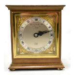ELLIOTT OF LONDON; a giltwood mantel clock, the silvered chapter ring set with Arabic and Roman
