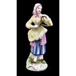 MEISSEN; a mid-18th century figure of 'The Lady Triangle Player' from the 'Cris de Paris' series