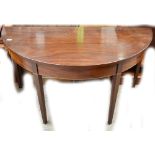 A late George III mahogany demi-lune side table raised on square sectioned tapering legs, width
