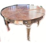 A mahogany Jupe-type dining table for restoration, diameter extended approx 183cm, unextended