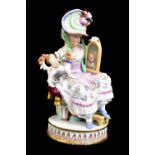 MEISSEN; a 19th century figure group of a seated woman showing her dog its reflection in a mirror,