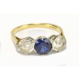 An 18ct yellow gold and synthetic corundum three stone dress ring, size Q1/2, approx 4.65g.