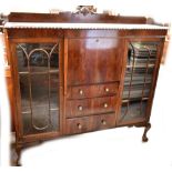An early 20th century reproduction mahogany bookcase with twin glazed doors, each enclosing two