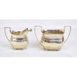 GEORGE NATHAN & RIDLEY HAYES; a George V hallmarked silver twin handled sugar bowl and cream jug