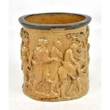 An early 19th century salt glazed cylindrical pot decorated with a Bacchanalian orgy and with base