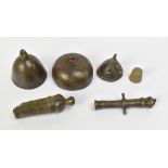 Two miniature archaic bronze bells, height of largest example 4cm, two miniature bronze cannons, etc