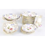 A 19th century hand painted twenty-six piece dinner service, with relief floral detail outside